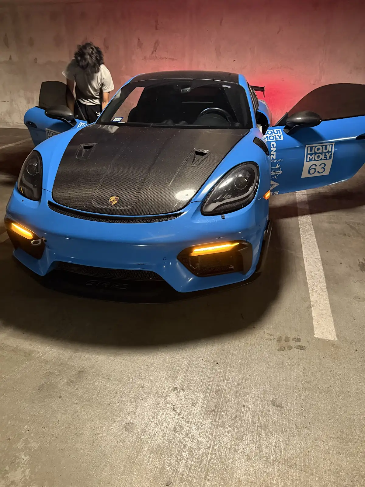 Blue sports car with clean paintwork after detailing