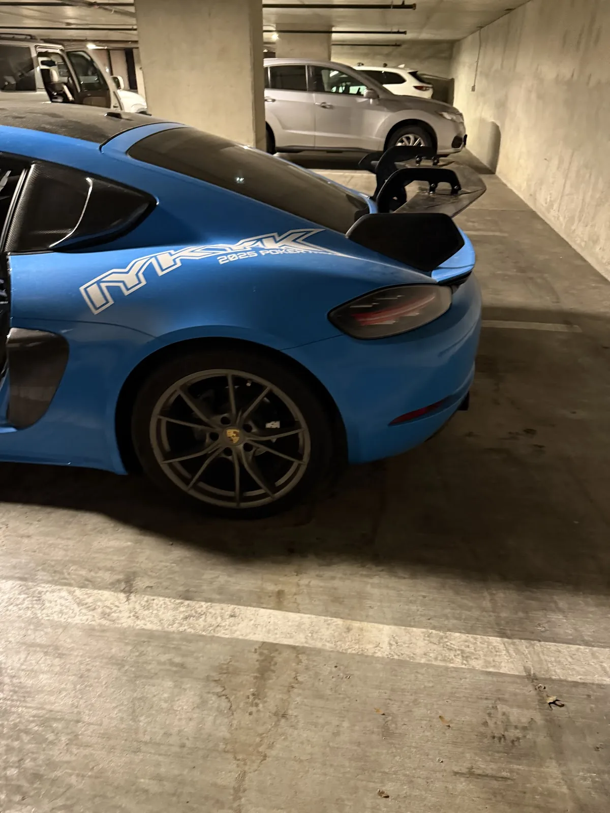 Rear quarter of a blue sports car with clean paint and wheels