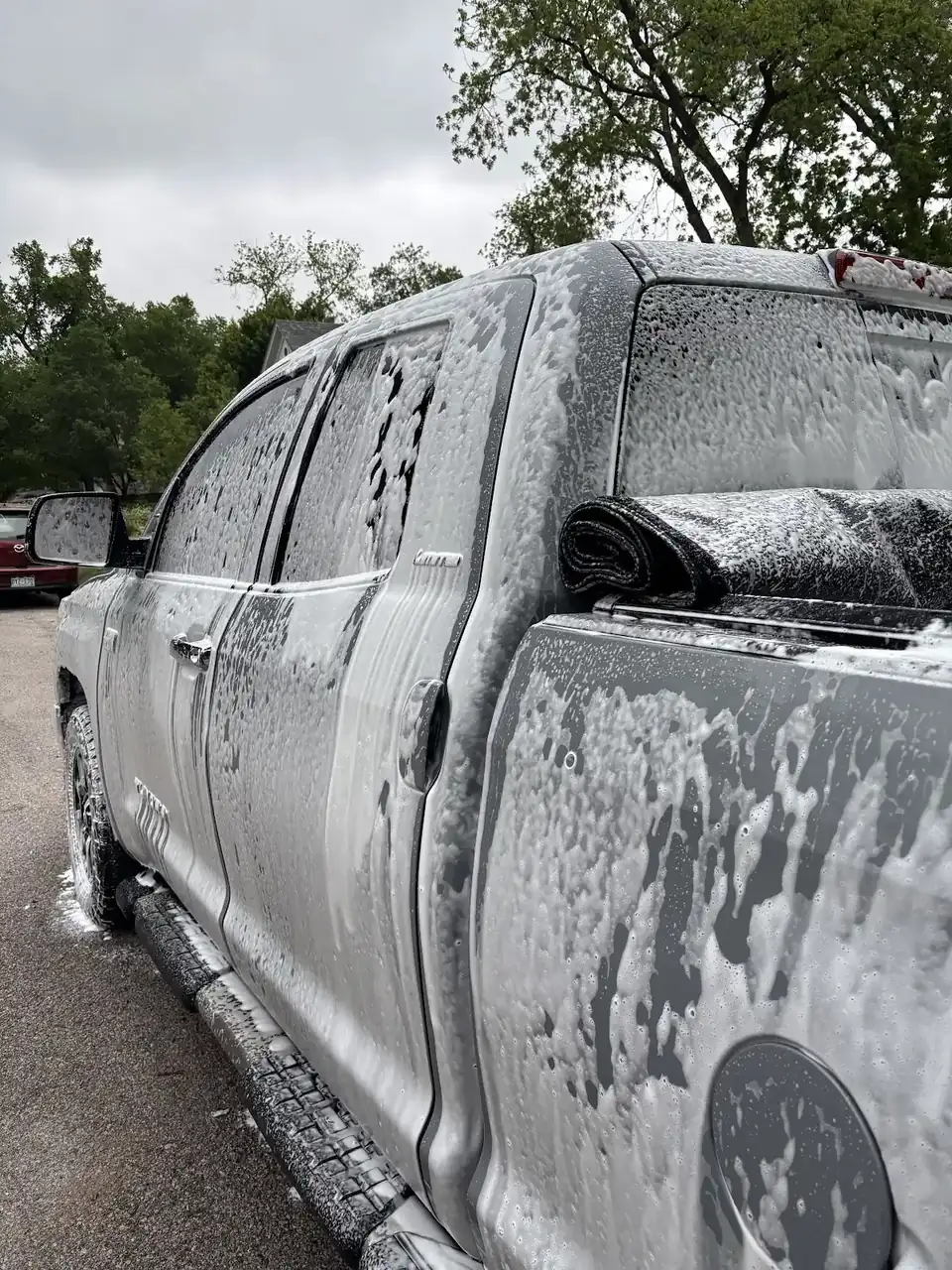 Pickup truck covered in foam along the driver's side