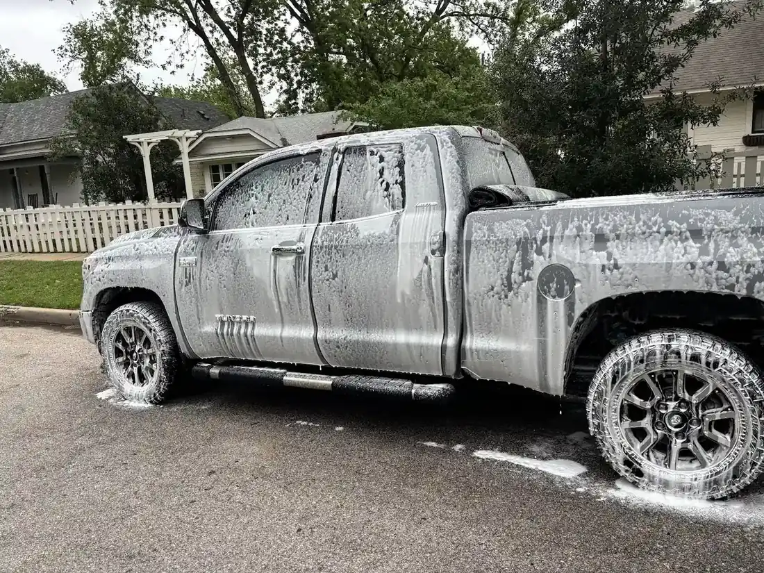 Side of a pickup truck covered in wash foam