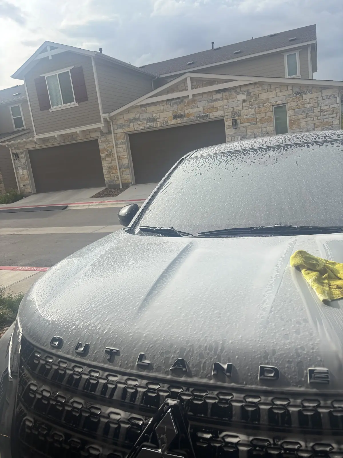 Foam-covered SUV hood during an exterior wash