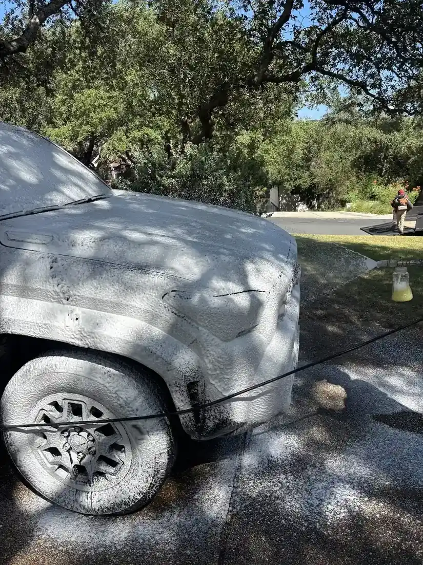 Front quarter of a truck coated in wash foam