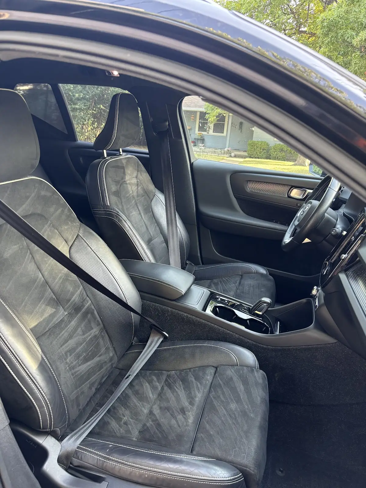 Cleaned front seats, console and door panel of a car interior
