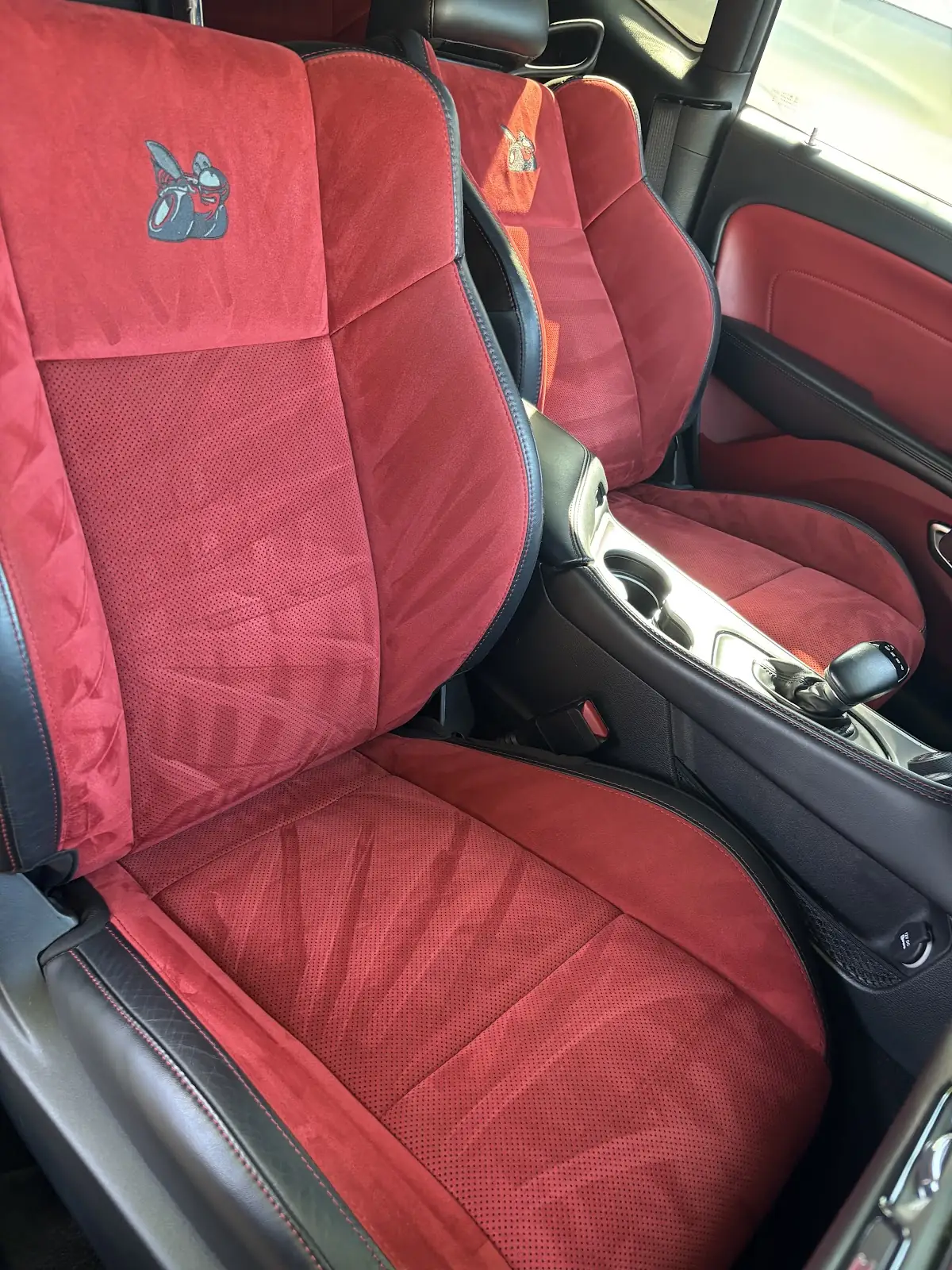 Red suede sport seats cleaned inside a car interior